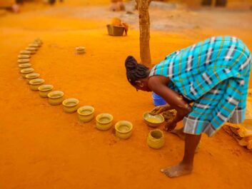 Woman making clay pots near Tsévié